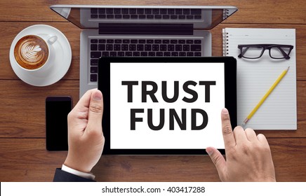 TRUST FUND , On The Tablet Pc Screen Held By Businessman Hands - Online, Top View