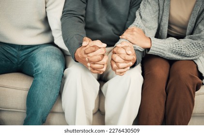 Trust, love and family holding hands on sofa for comforting embrace, prayer and support together at home. Solidarity, empathy and connected parents and adult children for care, compassion and praying - Powered by Shutterstock