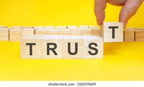 trust symbol. businessman turns wooden cubes the words renew. beautiful yellow background, copy space. business, concept