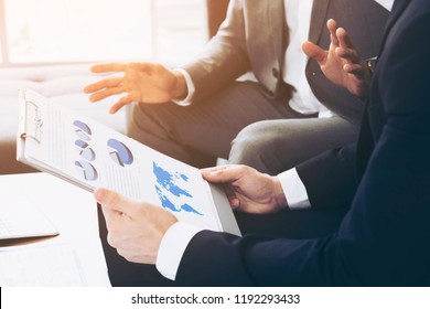 Trust in team concept. image of Business People discussing with Financial charts showing growing revenue and the results of their successful teamwork. together - Powered by Shutterstock