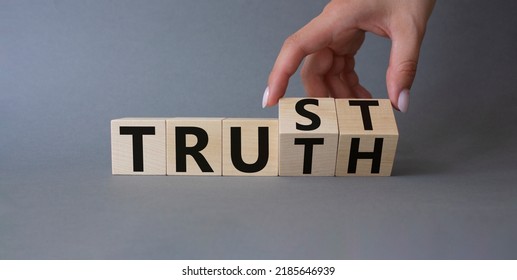 Trust And Truth Symbol. Businessman Hand Turnes Cubes And Changes Word Truth To Trust. Beautiful Grey Background. Business And Trust And Truth Concept. Copy Space