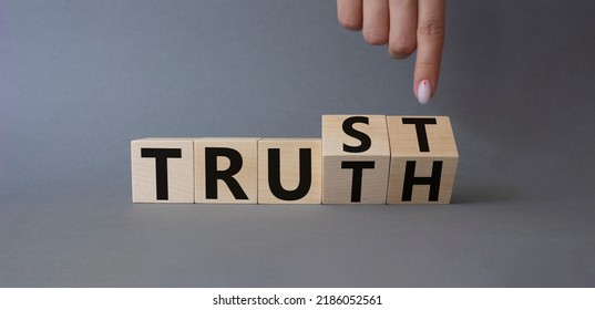 Trust And Truth Symbol. Businessman Hand Turnes Cubes And Changes Word Truth To Trust. Beautiful Grey Background. Business And Trust And Truth Concept. Copy Space