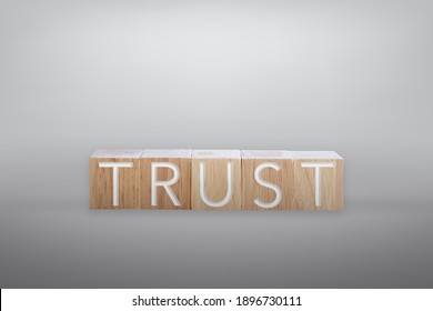 Trust word on wooden board with color background.