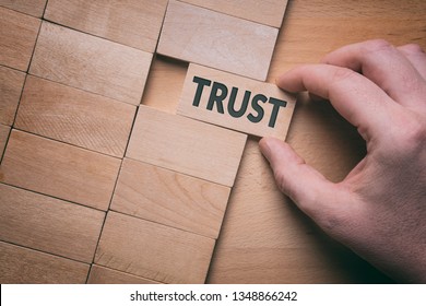 Trust Word Written On Wooden Block. Building Trust Business Concept.