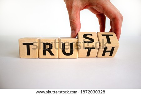 Truth or trust symbol. Male hand turns wooden cubes and changes the word 'Truth' to 'Trust'. Beautiful white background. Business and truth or trust concept, copy space.