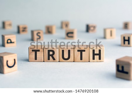 Truth - word from wooden blocks with letters, real facts truth  concept, random letters around, white  background
