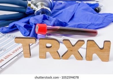 TRXN Medical Laboratory Acronym Or Abbreviation Of Transfusion Reaction Evaluation, Blood Allergic Reaction. Letters TRXN Are Near Laboratory Test Tubes With Blood Sample, Stethoscope Protection Glove