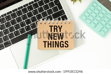 Try New Things card on pink background office desk