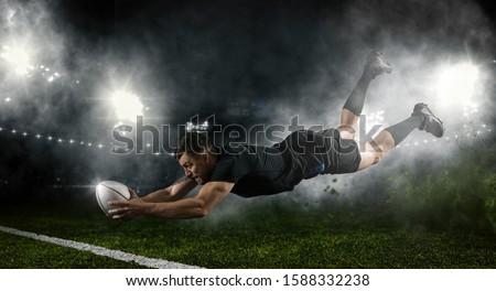 Try.  Rugby football player in action on dark arena background ストックフォト © 