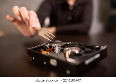 Trying to scrape the surface of the hard drive with a fork