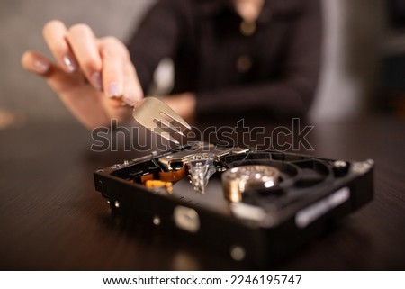 Trying to scrape the surface of the hard drive with a fork