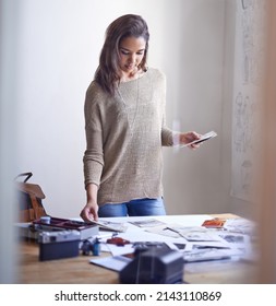 Trying To Select The Right Series Of Images. A Young Woman Working On Her Portfolio At Home.