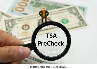 TSA PreCheck.Magnifying glass showing the words.Background of banknotes and coins.basic concepts of finance.Business theme.Financial terms. - Shutterstock ID 2155583297
