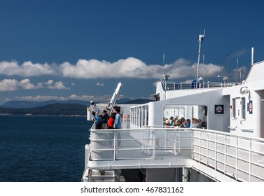 TSAWWASSEN, BRITISH COLUMBIA, CANADA - AUGUST 04, 2016: Passengers on the sun deck of the BC Ferry.  BC Ferries provides an essential link from mainland British Columbia to the various islands.