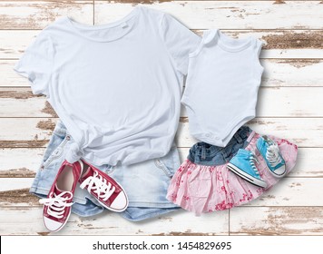 T-shirt design fashion concept, closeup of woman and baby in blank white t-shirt, shirt front isolated. Mock up for sublimation.