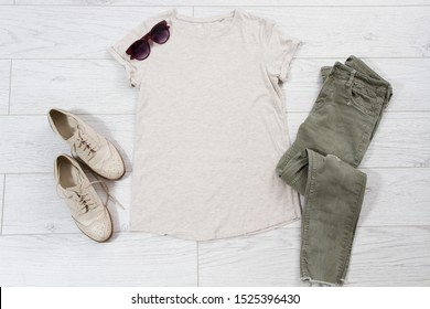 T-shirt Mock Up On Wooden Background, Sunglasses, Women's Shoes And Casual Pants Top View