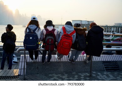 Tsim Sha Tui, Kowloon, Hong Kong - 2 Dec 2017: Some Youngsters Sitting At The Harbour Front And Enjoying The Moment.