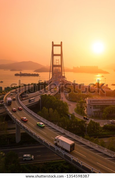 Tsing Ma Bridge. Highways in Hong kong with\
structure of suspension architecture in transportation and travel\
concept, Urban city at\
sunset.