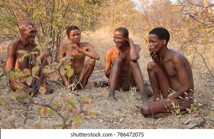 TSUMEB, NAMIBIA - August 28th 2017: Friendly and sociable Bushman tribe gathering and sharing cultural traditions such as making fire, smoking and hunting. 