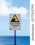 A tsunami warning sign with the Pacific Ocean in the background, Easter Island, Chile, Oceania