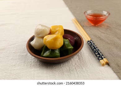 Tteok, songpyeon, rice cake, halfmoon shaped rice cake, korean traditional snack, colorful rice snack, mochi on the plate with drink