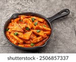 Tteokbokki is a Korean dish of rice flour cooked in spicy and sweet gochujang seasoning.