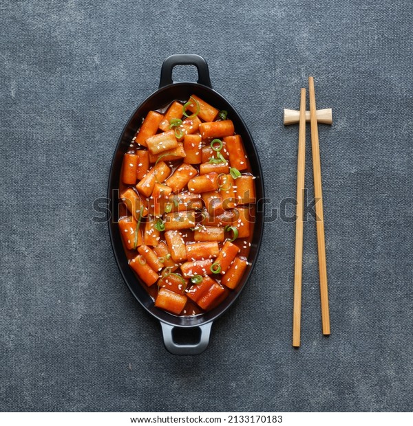 Tteokbokki, or\
simmered rice cake, is a popular Korean food made from\
small-sized garae-tteok (long, white, cylinder-shaped rice cakes)\
called tteokmyeon (rice cake\
noodles)