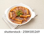 Tteokbokki or Topokki, stir fried rice cake stick, popular Korean street food with spicy gochujang sauce and sesame seed. 