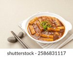 Tteokbokki or Topokki, stir fried rice cake stick, popular Korean street food with spicy gochujang sauce and sesame seed. 
