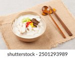 Tteokguk is a food made by thinly slicing rice cakes diagonally and boiling them in clear soybean soup.