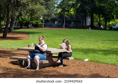 Tualatin, OR, USA - May 21, 2022: People enjoy the warm and sunny weather in Tualatin Community Park on Saturday.