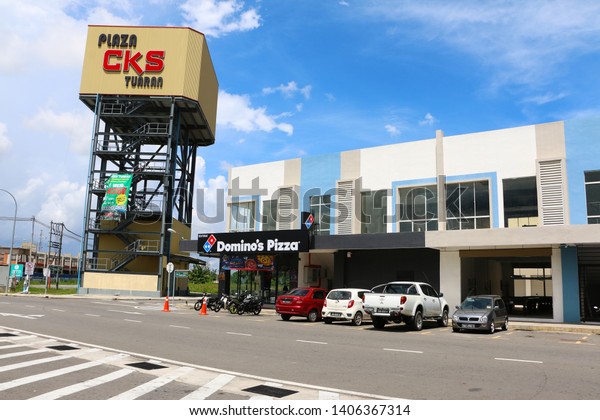 TUARAN, SABAH, MALAYSIA-MAY 23, 2019: Plaza CKS\
Tuaran Tower with blue sky background next to Domino Pizza\
restaurant in Plaza CKS Tuaran,\
Sabah