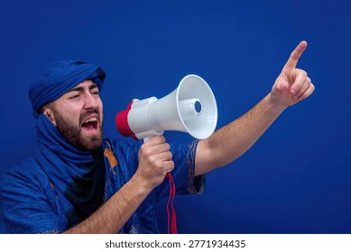Tuareg man shouting message using megaphone