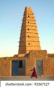 A Tuareg Man Walking In Front Of The Agadez Mud Mosque