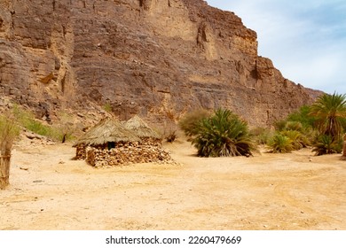 Tuareg village with traditional stone-built houses  in  Oued Aharhar Gorge. Aharghar Canyon,Tassili n'Ajjer National Park, Illizi Province, Djanet, Algeria, Africa.  - Shutterstock ID 2260479669