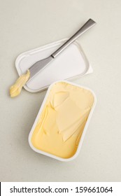 A Tub Of Butter On A Kitchen Bench