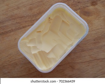 A Tub Of Margarine Standing On Kitchen Board. 