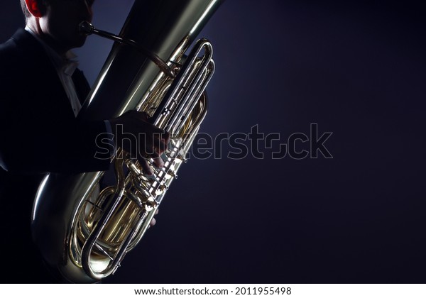 Tuba player brass instrument. Hands playing\
euphonium. Wind instruments\
closeup