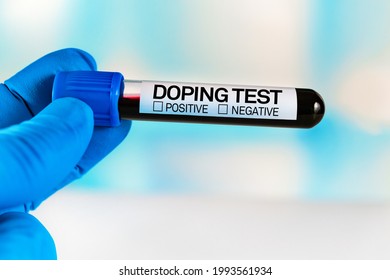 Tube of blood for analysis labeled Doping Test. Lab technician holding a blood sample tube for analysis doping substances in the laboratory