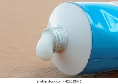 A tube of generic ointment or cream with a droplet squeezed out