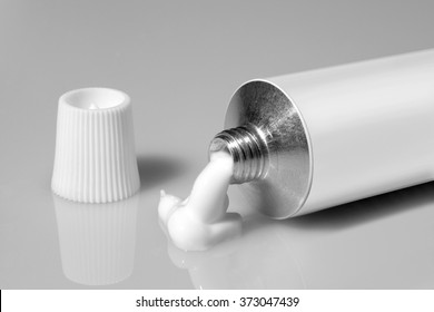 tube of white color on a gray background