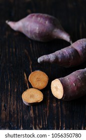 Tubers Of Sweet Potato Or Yams On A Dark Wooden Background. Jewel Yams 