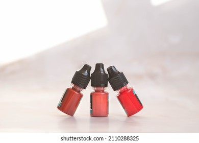tubes with pigments for permanent lip makeup on a light background