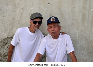 Tubigon, Bohol, Philippines - Jan 2019: Two Filipino Senior Citizens Pose For The Camera While At An Association Meeting.