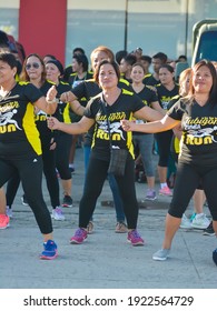 Tubigon, Bohol, Philippines - May 2019: A Group Zumba Class With All The Women Wearing Matching Outfits. At An Open Area Near The Town Plaza. Popular Exercise Fad In The Country.