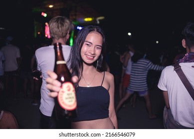 Tubigon, Bohol , Phillippines - May 2022: A Young Woman Holding Red Horse Beer Enjoys An Outdoor Disco, A Popular Street Dance Party Usually Occurring At The Town Plaza The Night Of The Fiesta.