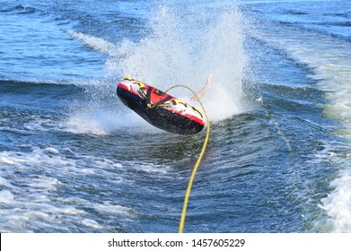 Tubing Behind A Boat And Catching A Wake From The Boat