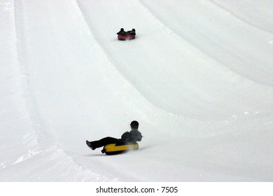 tubing down a snowy hill