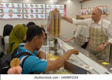 TUBINGEN/GERMANY-JULY 31 2018: Some Asian Tourists Are Buying Ice Cream At A Famous Gelato Shop In Tubingen City. They Look Busy Choosing The Taste Of Ice Cream