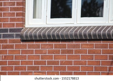 Tuck pointing on a federation house. Tuck pointed dark bullnose bricks under a the white window. Two contrasting colours of mortar in the mortar joints of brickwork. Inner West